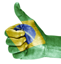 Sinal de positivo com a bandeira do Brasil